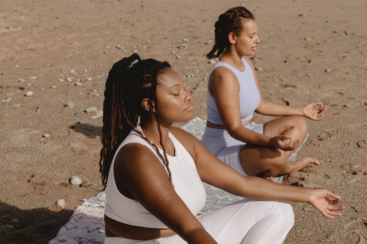 Women Doing Yoga at the Beach