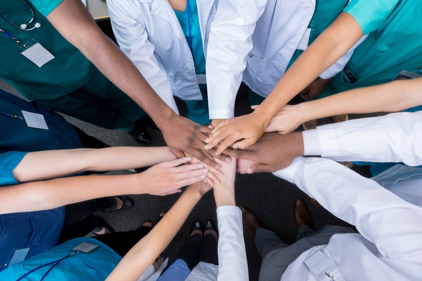 Group of medical students stacking hands